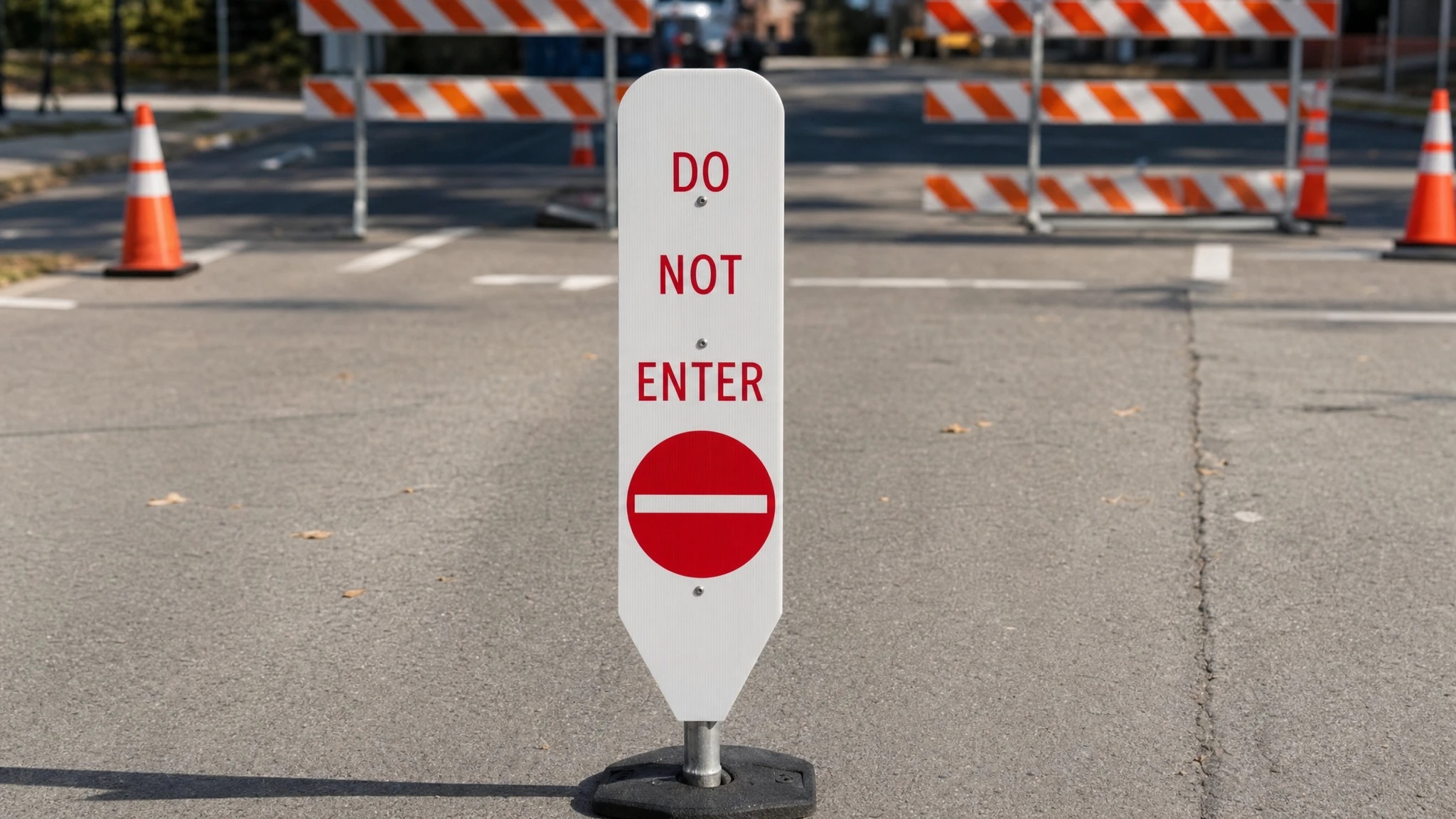 Do Not Enter coroplast road sign on a traffic barricade